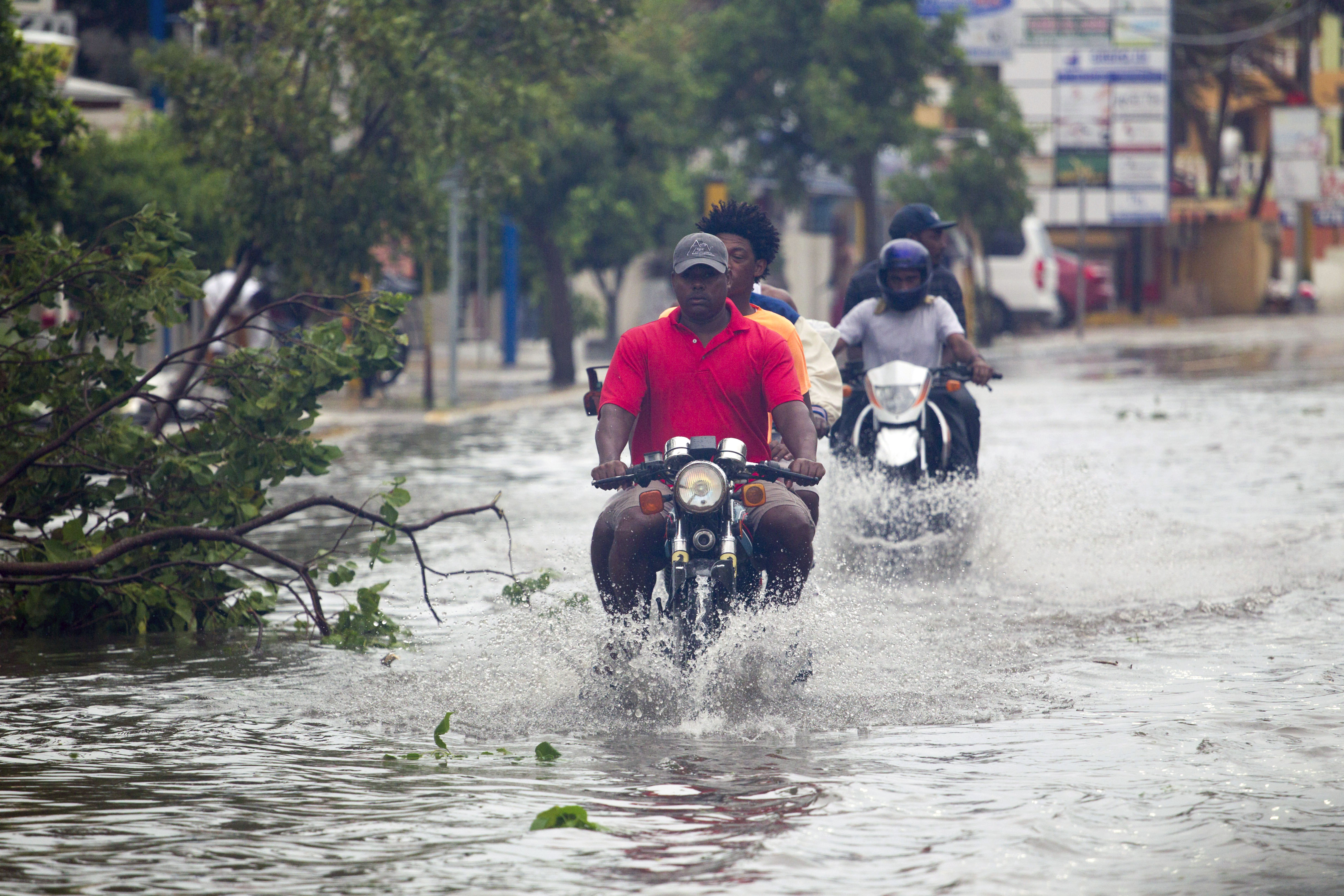 Men ride motorcycles along the flooded streets of Punta Cana in the Dominican Republic on September 20th, 2017.