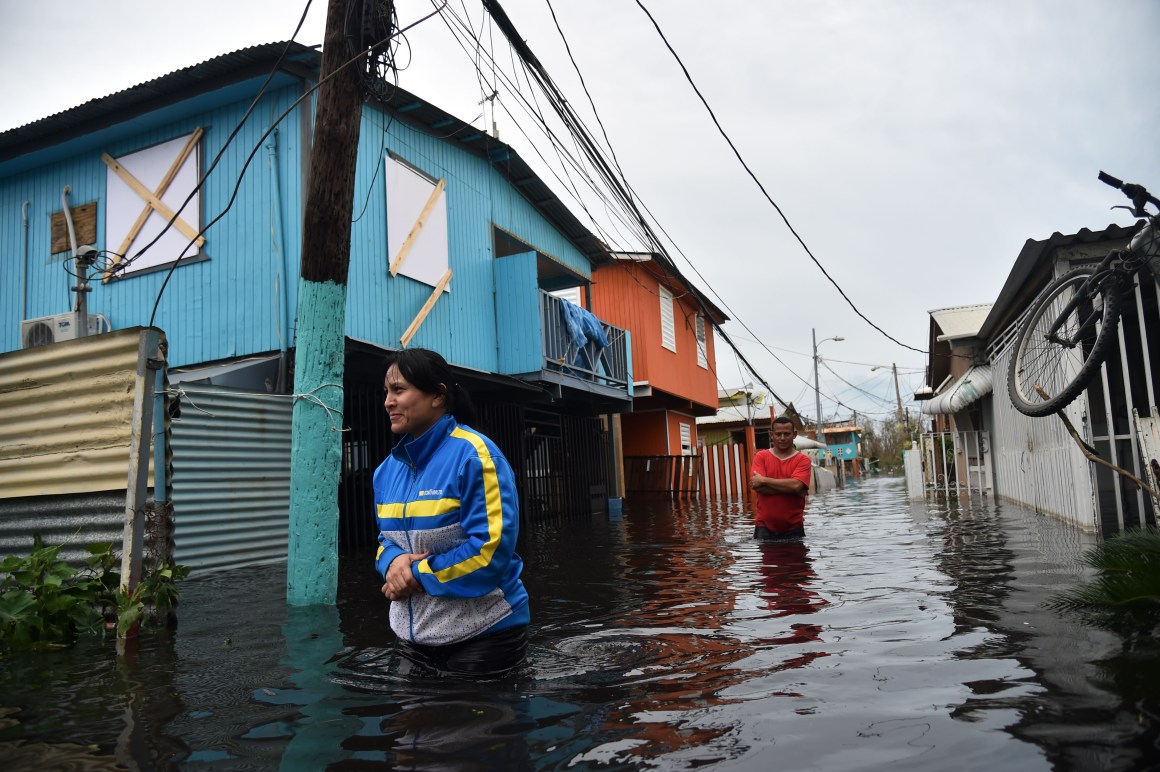 People walk across a flooded street in Juana Matos, Puerto Rico, on September 21st, 2017.