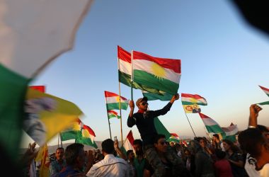 Syrian Kurds wave the Kurdish flag in the Syrian city of Qamishli on September 27th, 2017, during a gathering in support of the independence referendum in Iraq's northern Kurdish region.