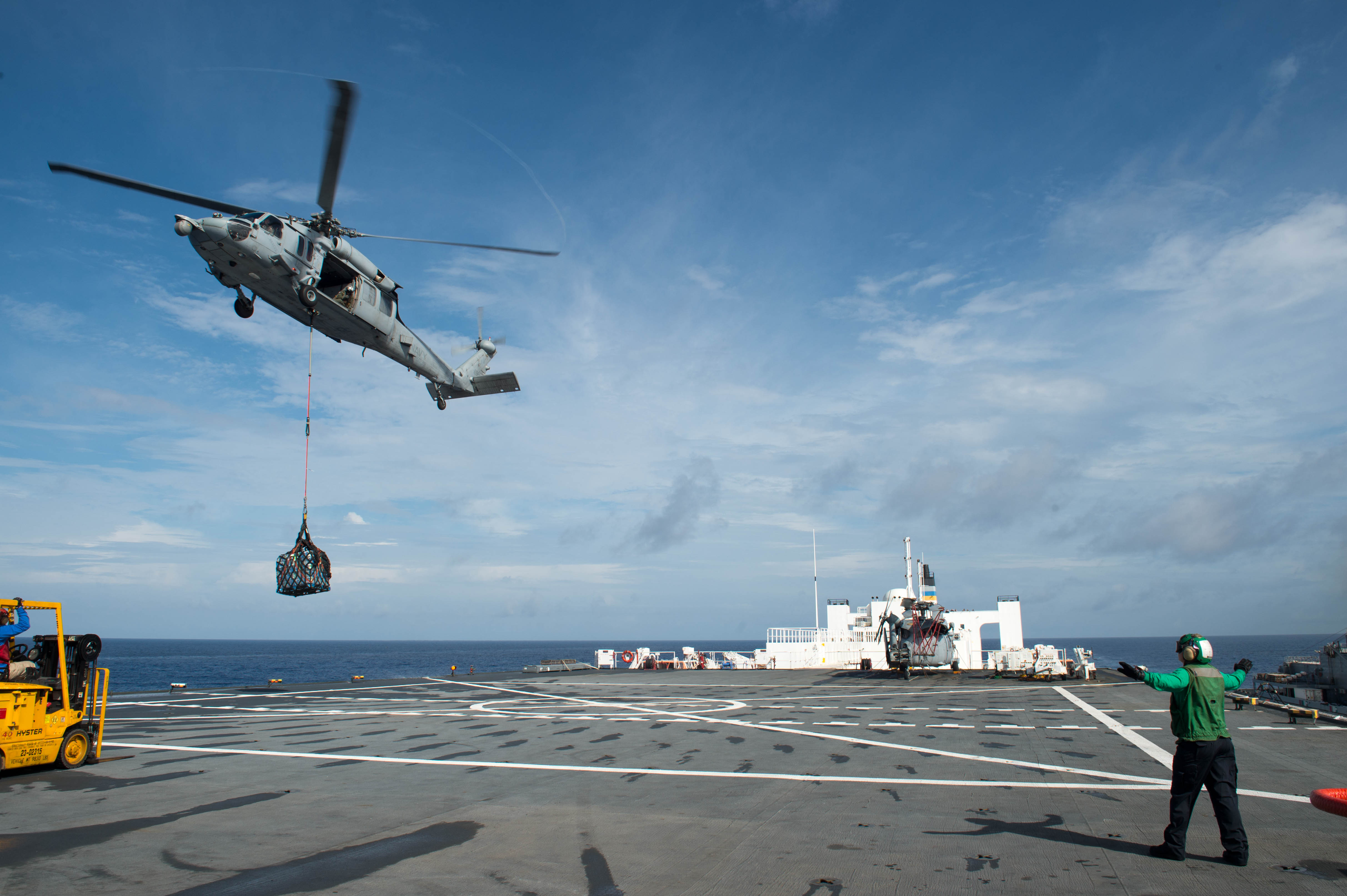 An MH-60S Sea Hawk helicopter attached to the Sea Knights Sea Combat Squadron 22 delivers cargo to the hospital ship USNS Comfort in support of humanitarian relief operations in Puerto Rico.