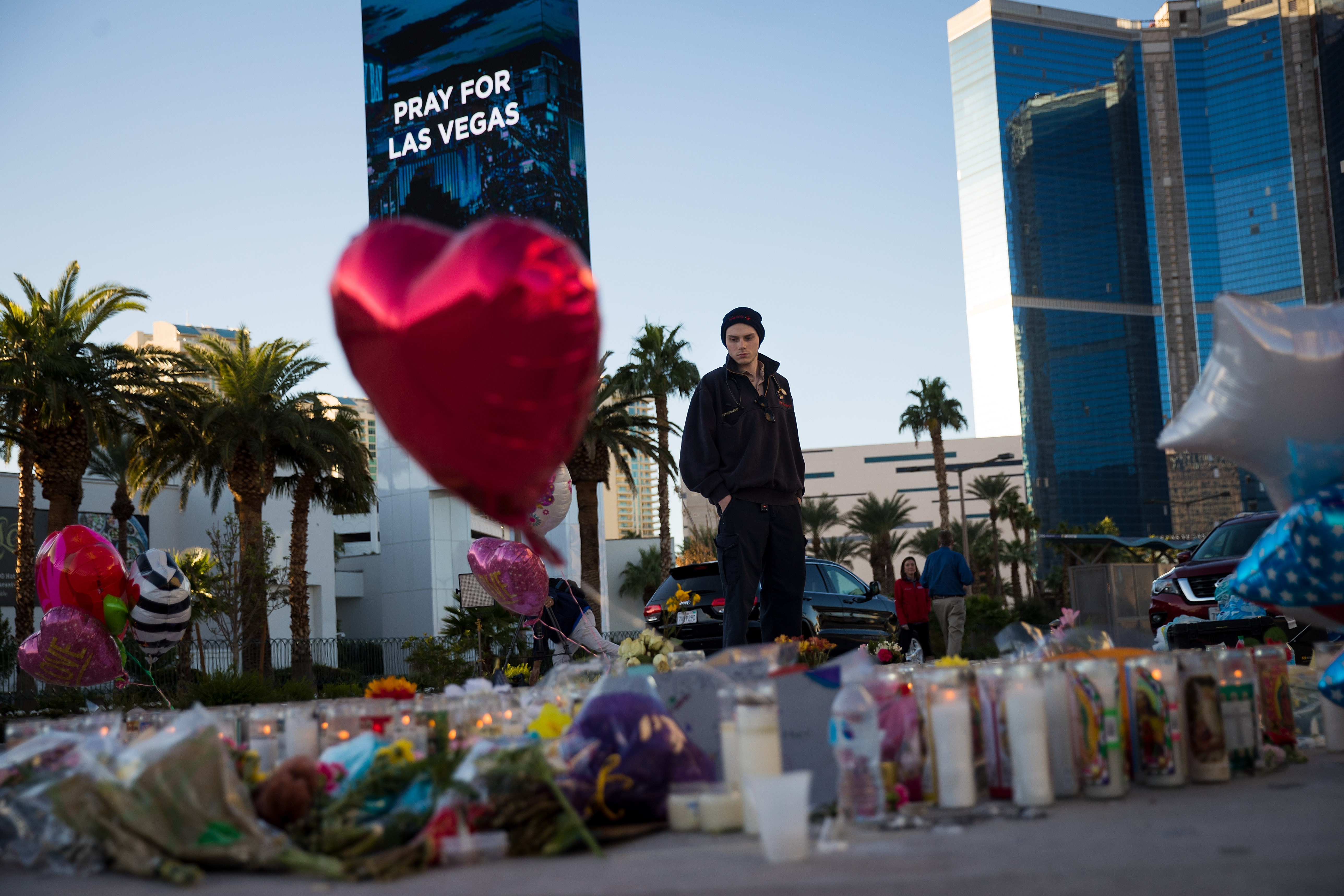 Matthew Helms, who worked as a medic the night of the shooting, visits a makeshift memorial for the victims of Sunday night's mass shooting on the north end of the Las Vegas Strip on October 3rd, 2017, in Las Vegas, Nevada.