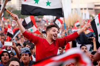 Syrians celebrate in Damascus' Umayyad Square on October 5th, 2017, after Syria's national soccer team scored in its match against Australia during the FIFA World Cup 2018 qualifier.