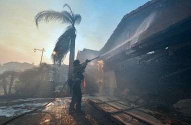 A fireman puts out a fire at a home in the Anaheim Hills neighborhood in Anaheim, California, on October 9th, 2017.