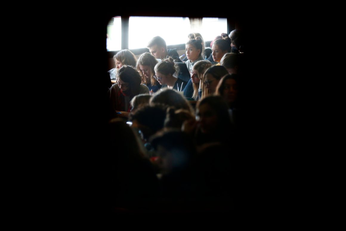 Students work in a lecture hall.