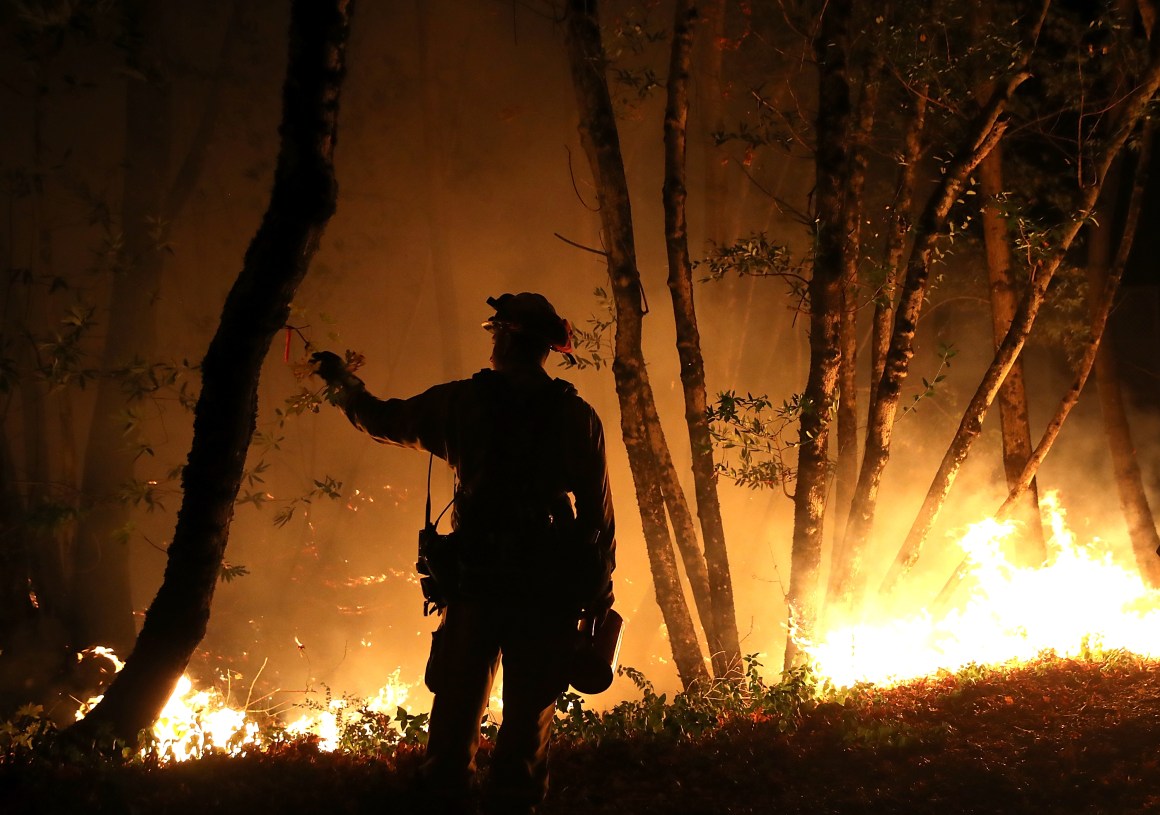 Cal Fire firefighter Brandon Tolp monitors a firing operation while battling the Tubbs Fire on October 12th, 2017, near Calistoga, California.