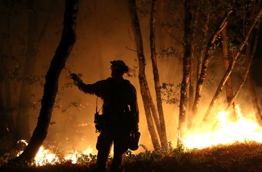 Cal Fire firefighter Brandon Tolp monitors a firing operation while battling the Tubbs Fire on October 12th, 2017, near Calistoga, California.