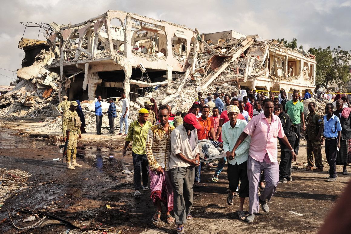 Somali men carry the body of a victim who died in the explosion of a truck bomb in the center of Mogadishu, on October 15th, 2017.