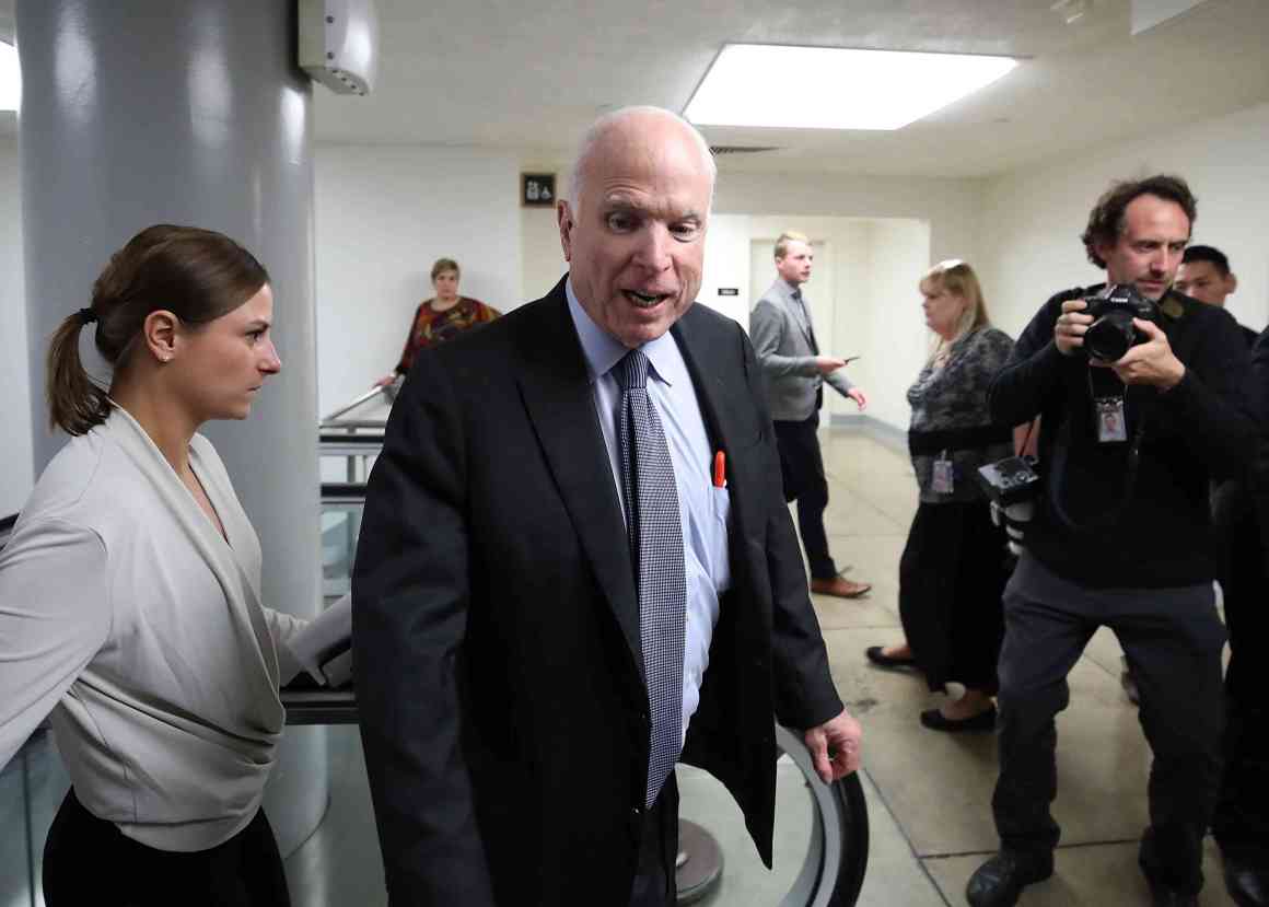 Senator John McCain (R-Arizona) talks to reporters as he walks to the Senate chamber for a series of roll call votes regarding the 2018 budget on October 18th, 2017, in Washington, D.C.