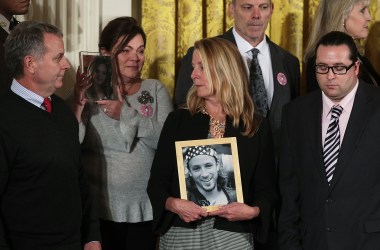 Families members hold pictures of the loved ones they lost to the opioid crisis during the event at which Trump declared the crisis a public-health emergency on October 26, 2017, in the East Room of the White House in Washington, D.C.