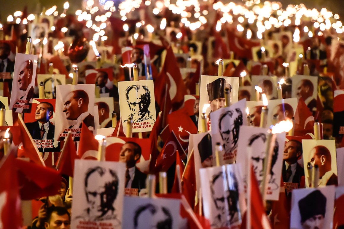 People hold torches and posters of Mustafa Kemal Ataturk, the founder of modern Turkey, during a march marking the 94th anniversary of Republic Day on October 29th, 2017, in Istanbul.