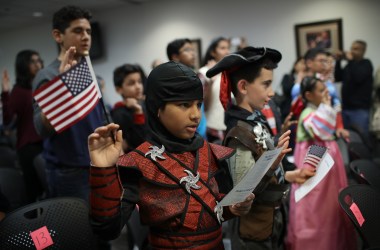 Dressed as a ninja, Shaheer Sarwar from Pakistan takes the oath of United States citizenship during a Halloween-themed citizenship ceremony on October 31st, 2017, in Fairfax, Virginia.