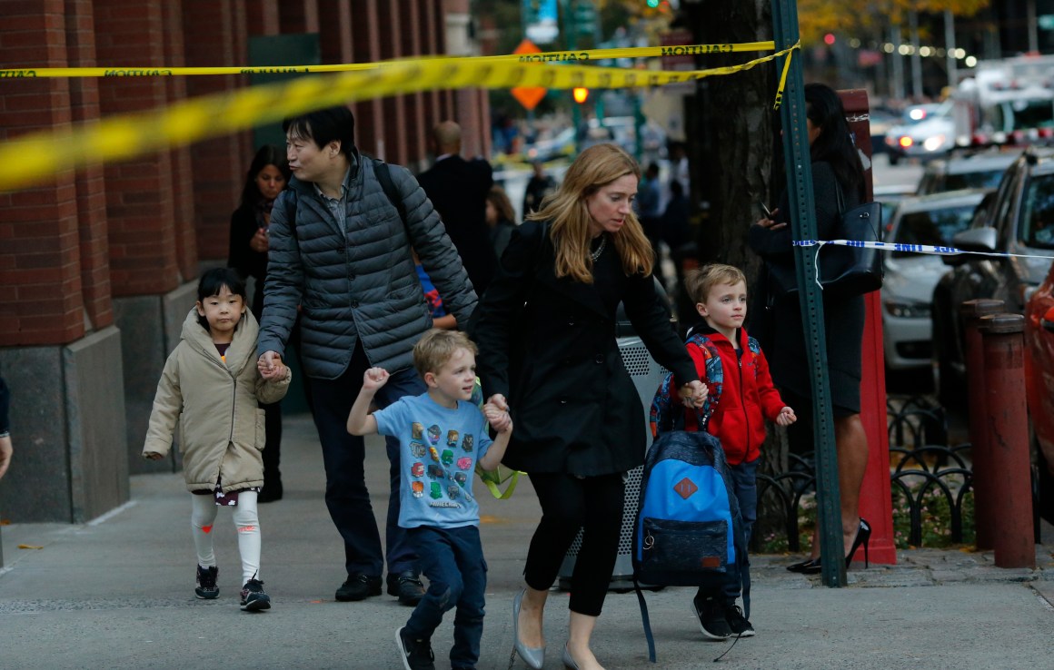 Children are evacuated from a school as emergency personal respond after a man driving a rental truck struck and killed eight people on a jogging and bike path in Lower Manhattan on October 31st, 2017, in New York City.