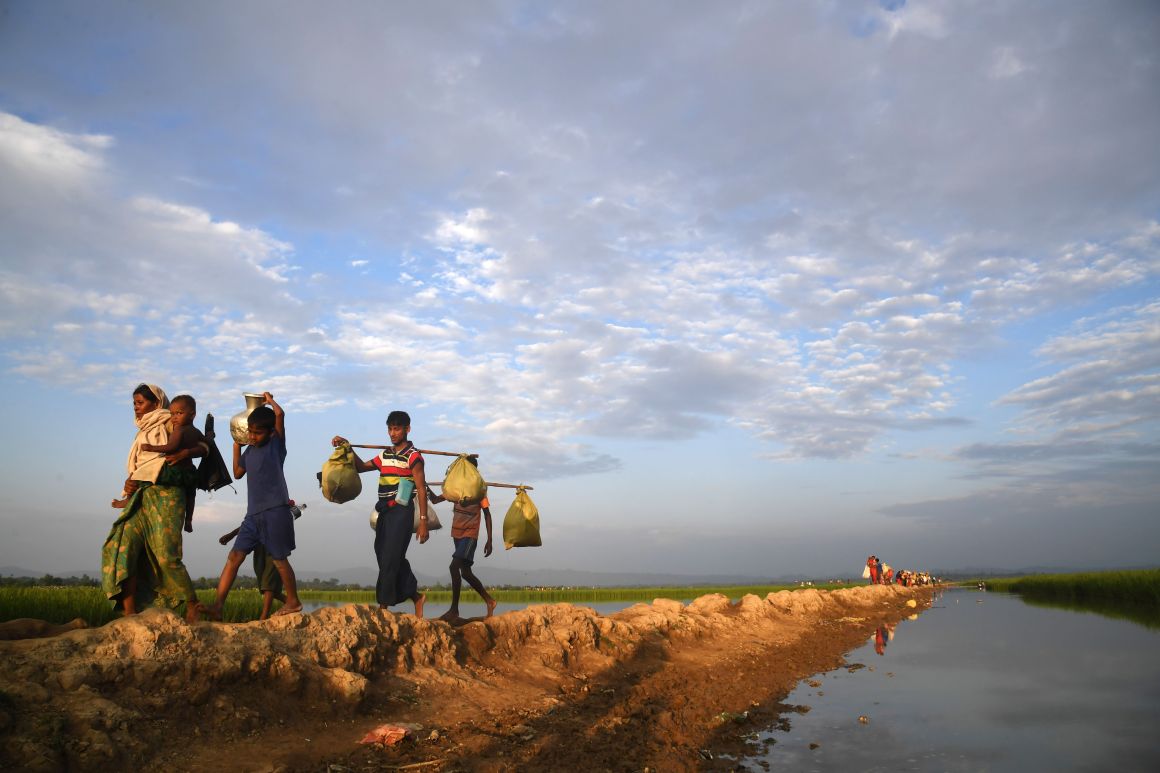 Rohingya Muslim refugees who were stranded after leaving Myanmar walk toward the Balukhali refugee camp in Bangladesh's Ukhia district on November 2nd, 2017. More than 600,000 Rohingya have arrived in Bangladesh since a military crackdown in Myanmar in August triggered an exodus.