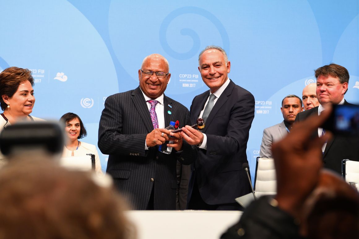 Salaheddine Mezouar (right), Moroccan foreign minister and president of COP22, hands over a symbolic hammer to Frank Bainimarama (left), prime minister of Fiji and president of COP23, during the opening session of the COP23 United Nations Climate Change Conference on November 6th, 2017, in Bonn, Germany.