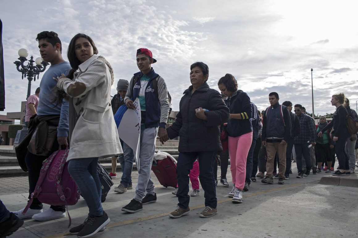 Central American migrants seeking asylum in the United States walk to the U.S.-Mexico border at El Chaparral port of entry on November 12th, 2017, in Tijuana, northwestern Mexico.