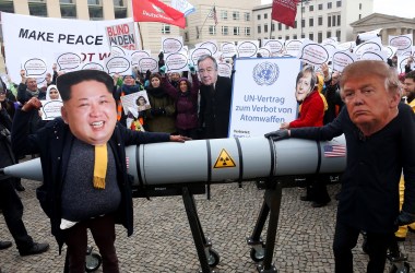 Activists dressed as North Korean leader Kim Jong-un and U.S. President Donald Trump march with a model of a nuclear rocket during a demonstration against nuclear weapons in Berlin on November 18th, 2017.