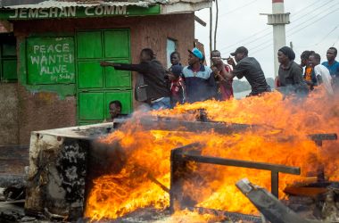 Supporters of Kenya's opposition party take shelter during a demonstration in Nairobi on November 20th, 2017, after Kenya's supreme court dismissed petitions to overturn the country's presidential election re-run, validating the poll victory of President Uhuru Kenyatta.