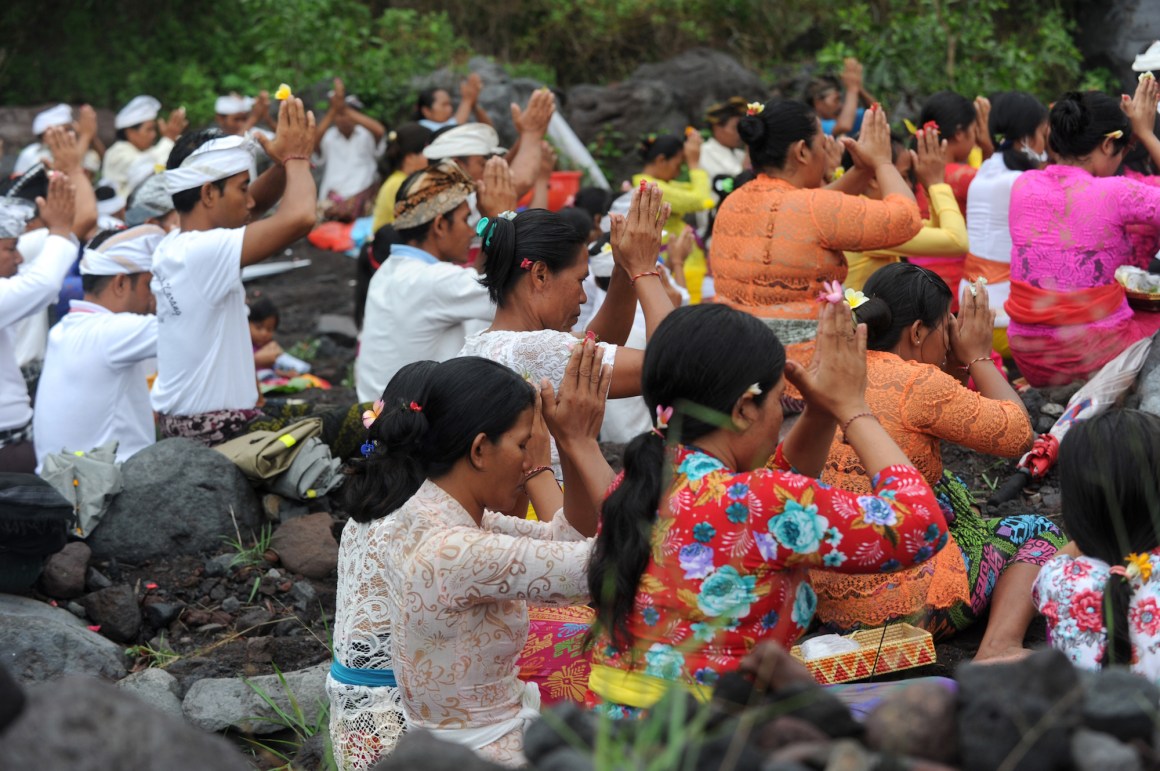 Balinese Hindus take part in a ceremony, where they pray near Mount Agung in hope of preventing a volcanic eruption, in Muntig village of the Kubu sub-district in Karangasem Regency on Indonesia's resort island of Bali on November 26th, 2017.