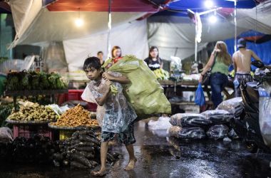 A boy collects used plastic bottles to be sold at a junk shop at Divisoria market in Manila, Philippines, on November 29th, 2017.