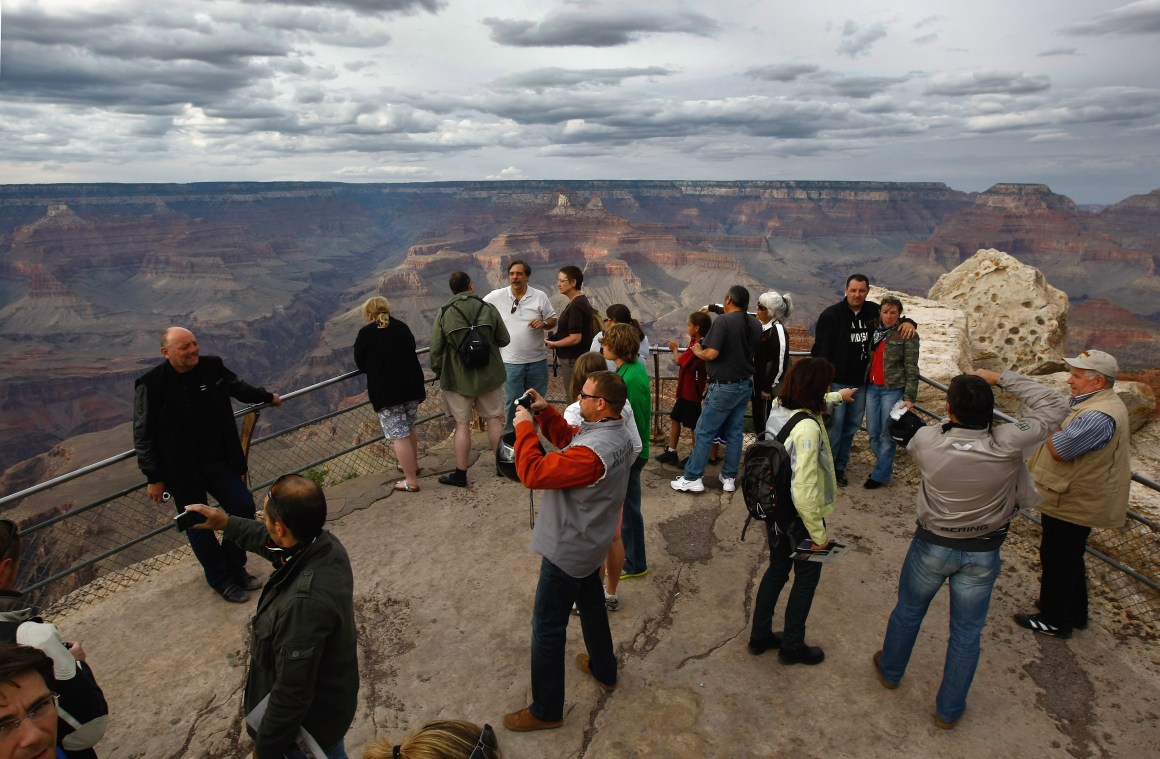 Tourists snap photos at Mather Point in the Grand Canyon National Park, Arizona.