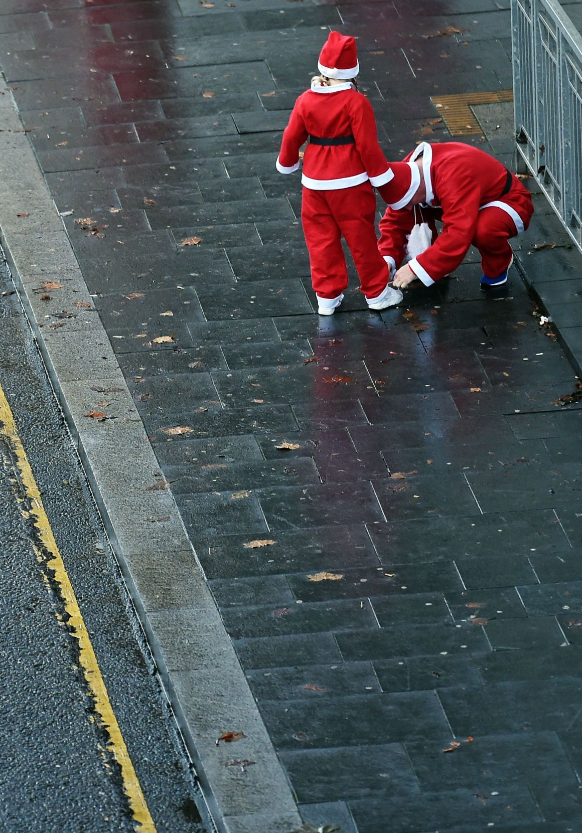 Runners dressed in Father Christmas costumes arrive to take part in the annual five kilometer Santa Dash in Liverpool, England, on December 3rd, 2017. Many runners wear a blue suit, usually the supporters of Everton football club, rather than a red one, as red is the color of their bitter rivals, the Liverpool football club.