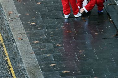 Runners dressed in Father Christmas costumes arrive to take part in the annual five kilometer Santa Dash in Liverpool, England, on December 3rd, 2017. Many runners wear a blue suit, usually the supporters of Everton football club, rather than a red one, as red is the color of their bitter rivals, the Liverpool football club.