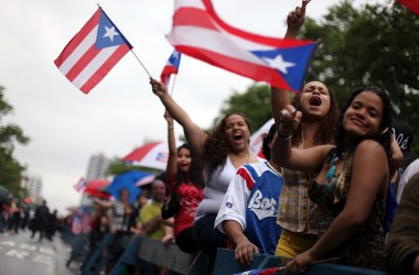 Girls wave Puerto Rican flags during the 2009 Street Festival in Spanish Harlem in New York City.