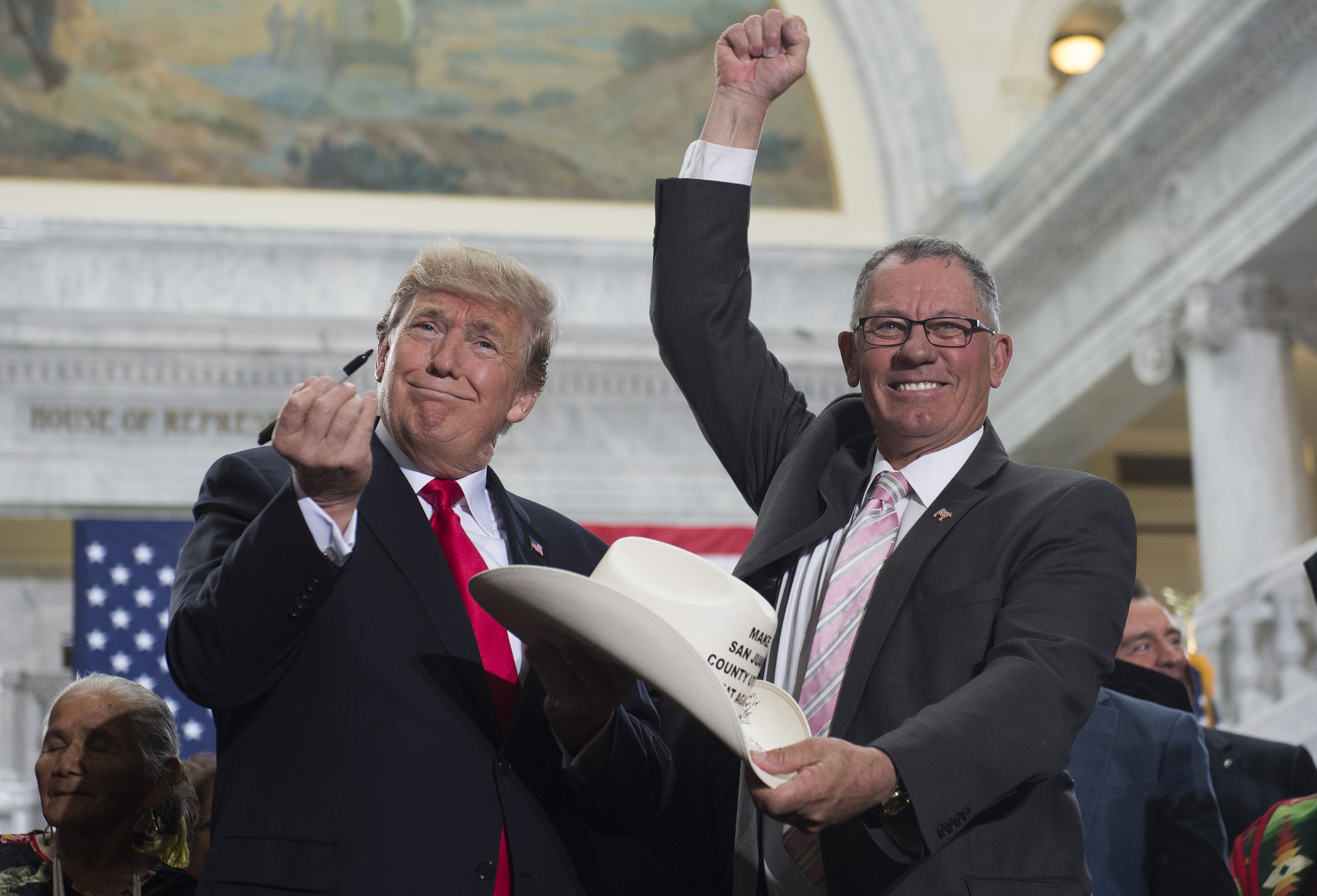 President Donald Trump holds up a pen after signing a presidential proclamation shrinking Bears Ears and Grand Staircase-Escalante national monuments at the Utah State Capitol in Salt Lake City, Utah, on December 4th, 2017.