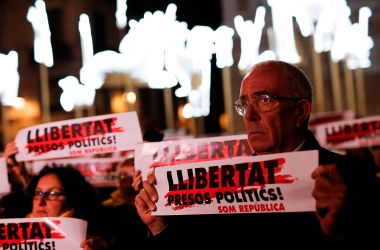 People hold banners reading Freedom for Political Prisoners in front of Barcelona's city hall on December 4th, 2017, during a demonstration demanding the release of jailed separatist leaders.