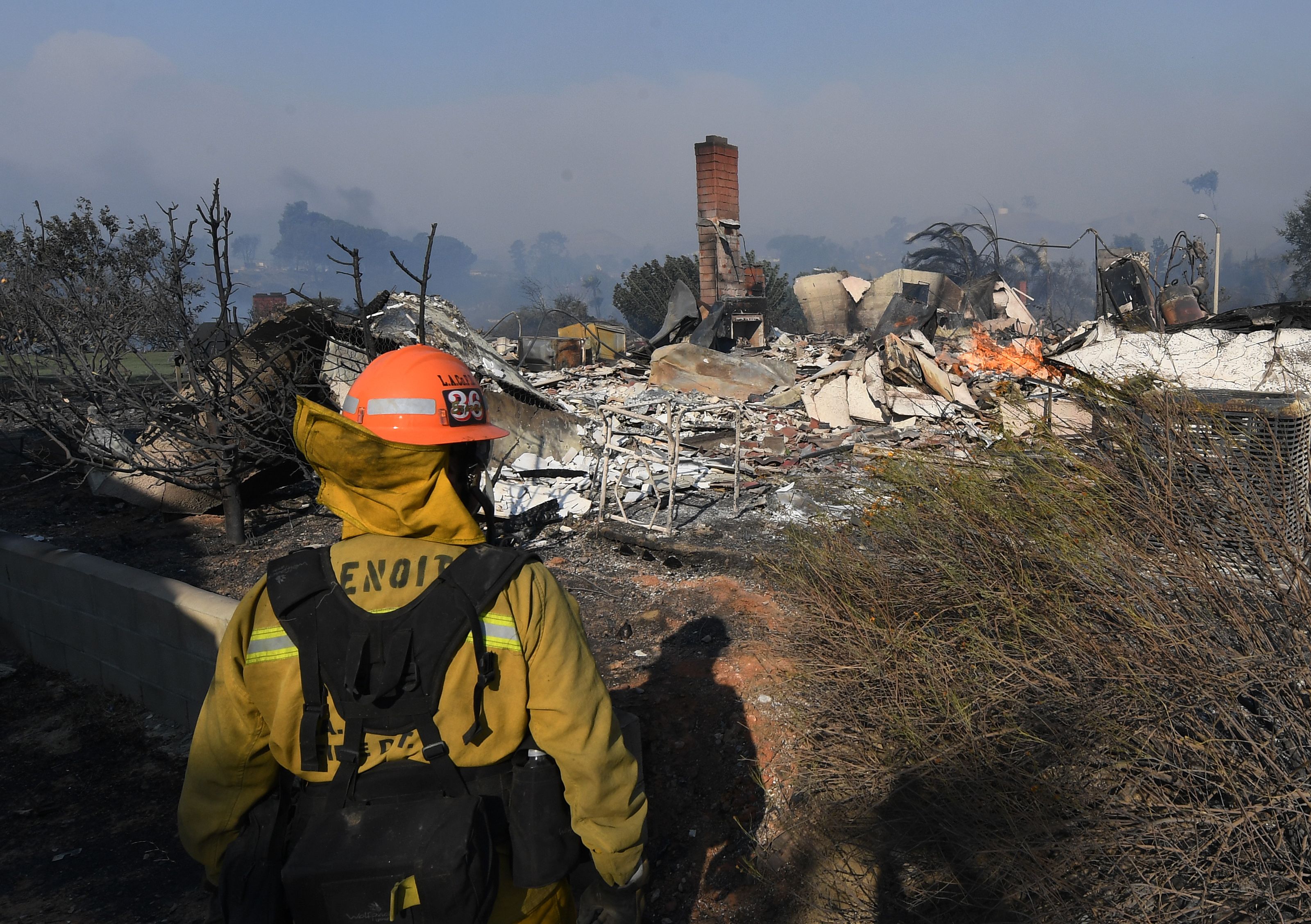 A firefighter looks at a house burnt to the ground during the Thomas wildfire in Ventura, California.