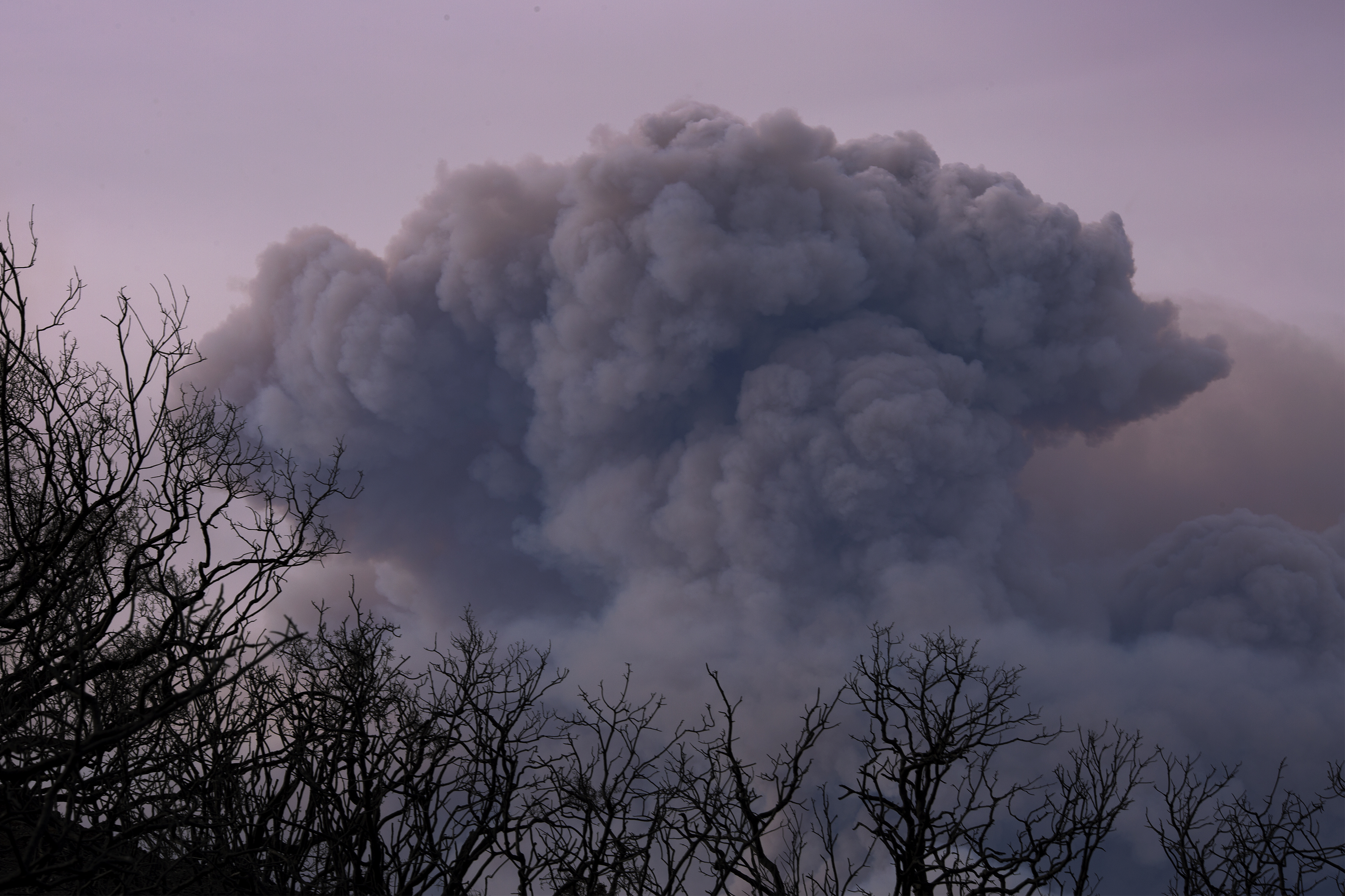 A plume of smoke is seen from Ojai, California, as the Thomas Fire grows and advances toward seaside communities on December 10th, 2017, near Carpinteria, California.