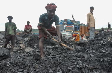 Workers collect coal at an open mine in Dhanbad in the eastern Indian state of Jharkhand on December 7th, 2017.