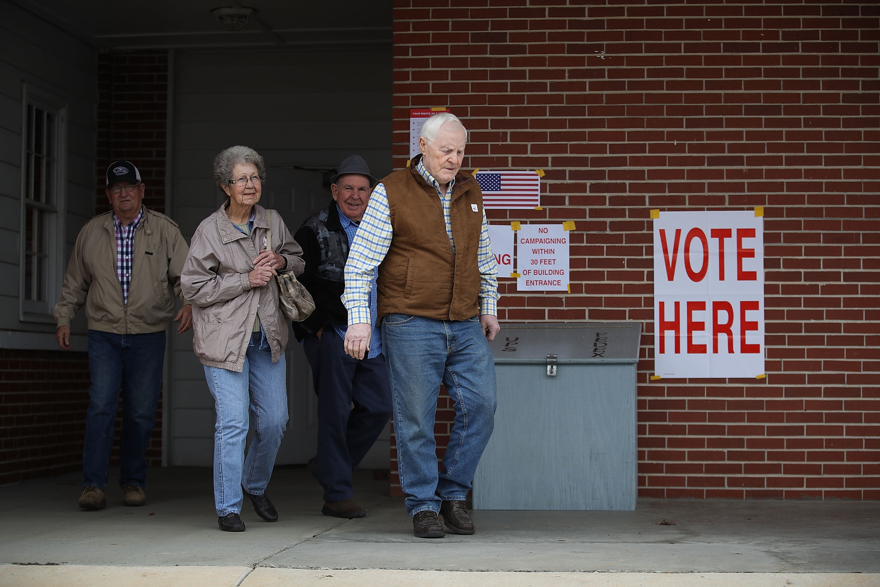 Voters exit after casting their ballots at a polling station setup in the Fire Department on December 11th, 2017, in Gallant, Alabama. Alabama voters are casting their ballot for either Republican Roy Moore or his Democratic challenger Doug Jones in a special election to decide who will replace Attorney General Jeff Sessions in the U.S. Senate.