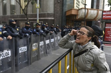 A demonstrator shouts slogans in front of the Senate building during a protest against the potential approval of an internal security law that would allow the army to act as police, in Mexico City, on December 14th, 2017. Mexican deputies approved a new security law that provides a legal framework for military deployment. The controversial initiative is being discussed in the Senate.