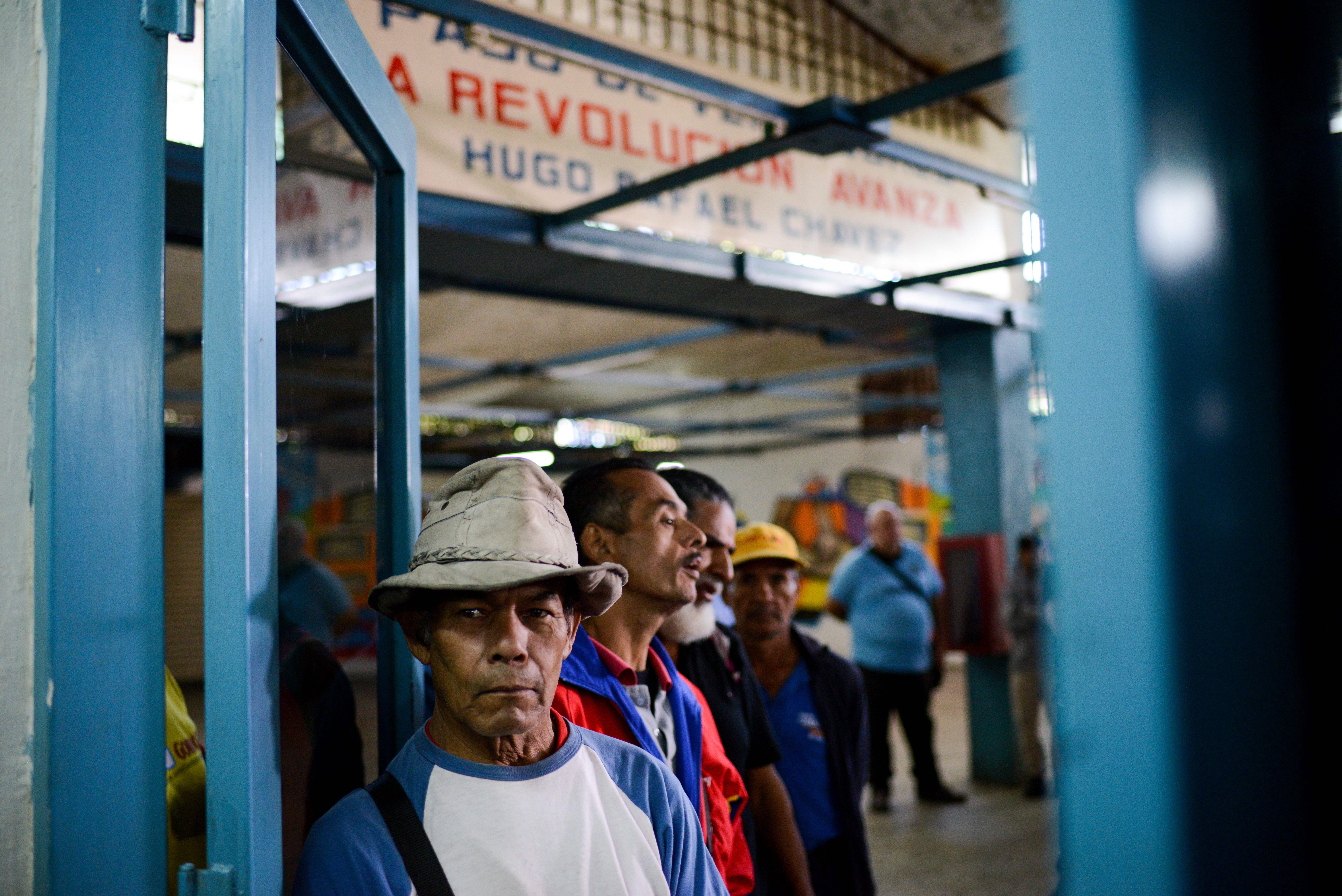 People line up outside the BanPanal communal bank to exchange bolivares for the new local community currency, the panal, launched in the 23 de Enero working-class neighborhood in Caracas, Venezuela, on December 15th, 2017.