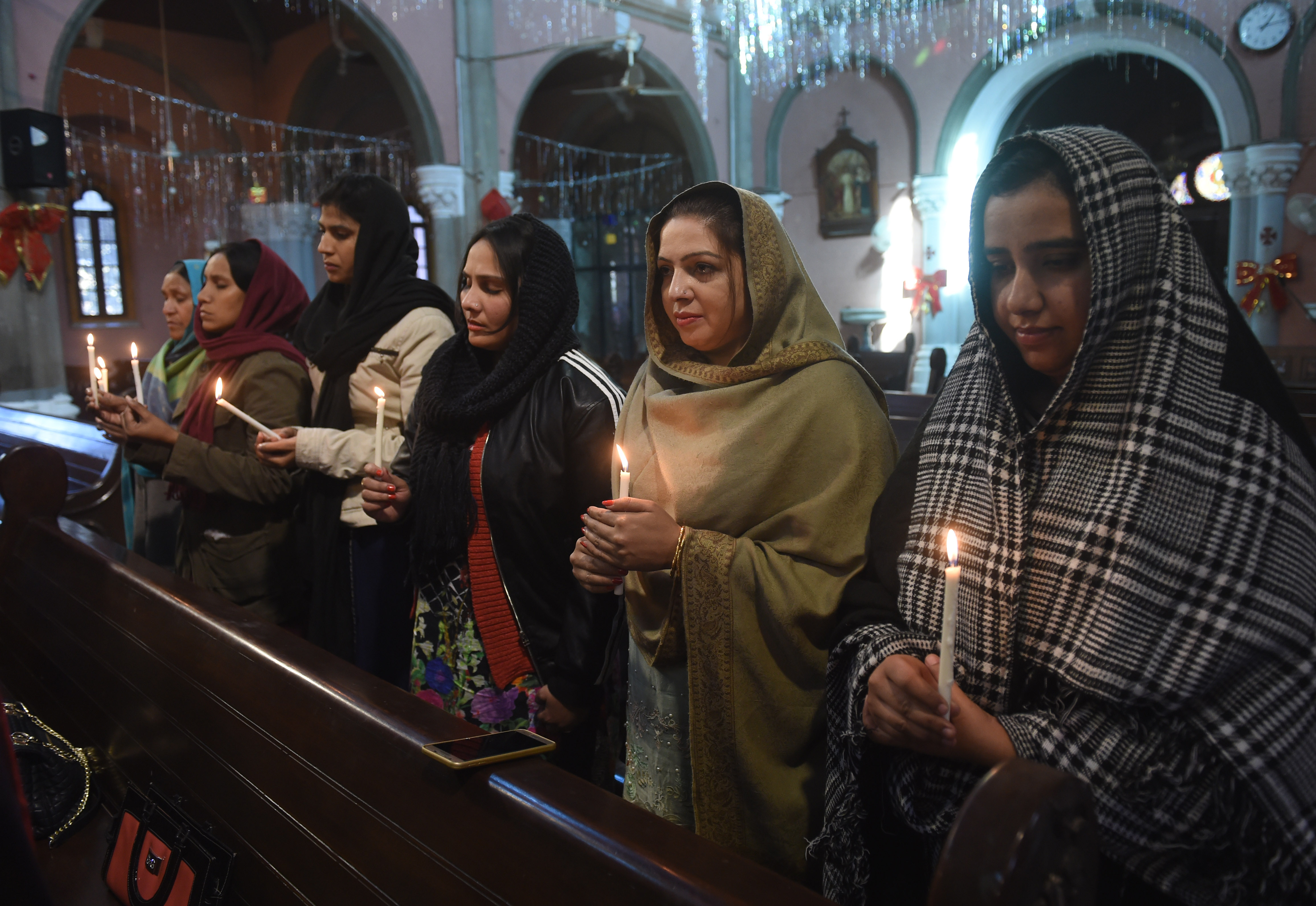 Pakistani Christians take part in a service on December 18th, 2017, for the victims of a suicide attack on a church at the Sacred Heart Cathedral in Lahore.