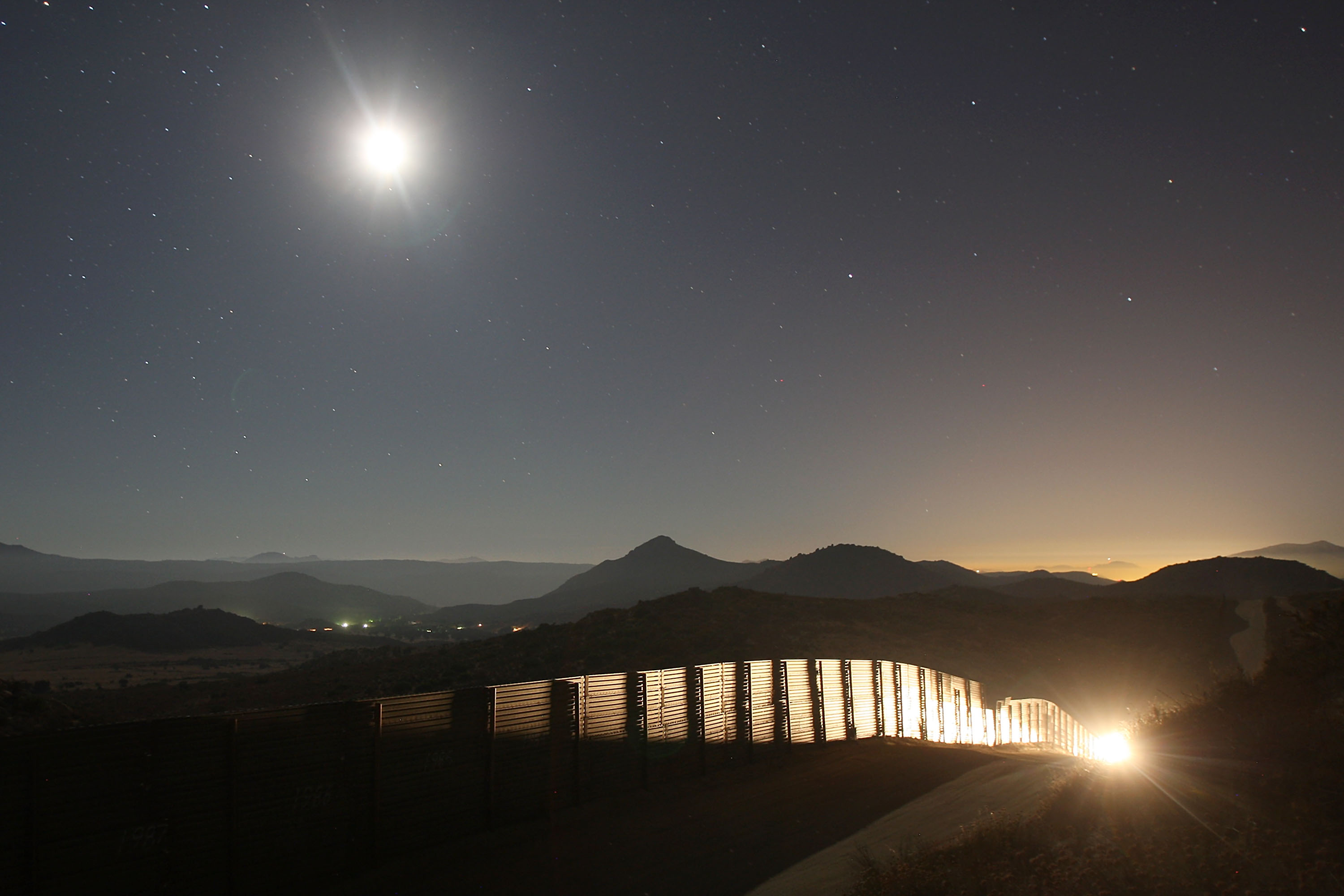 A U.S. Border Patrol vehicle is driven along the U.S.-Mexico border fence as agents carry out special operations near the rural town of Campo, some 60 miles east of San Diego, California.