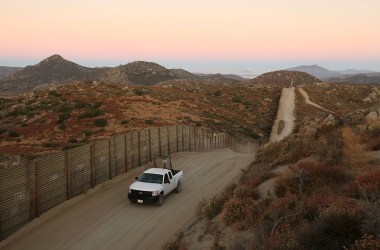 A U.S. Border Patrol agent searches for tracks after a night of surveillance using night-vision equipment as agents carry out special operations near the U.S.-Mexico border fence.