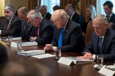 President Donald Trump bows his head during a prayer at a cabinet meeting in the White House in Washington, D.C., on December 20th, 2017.