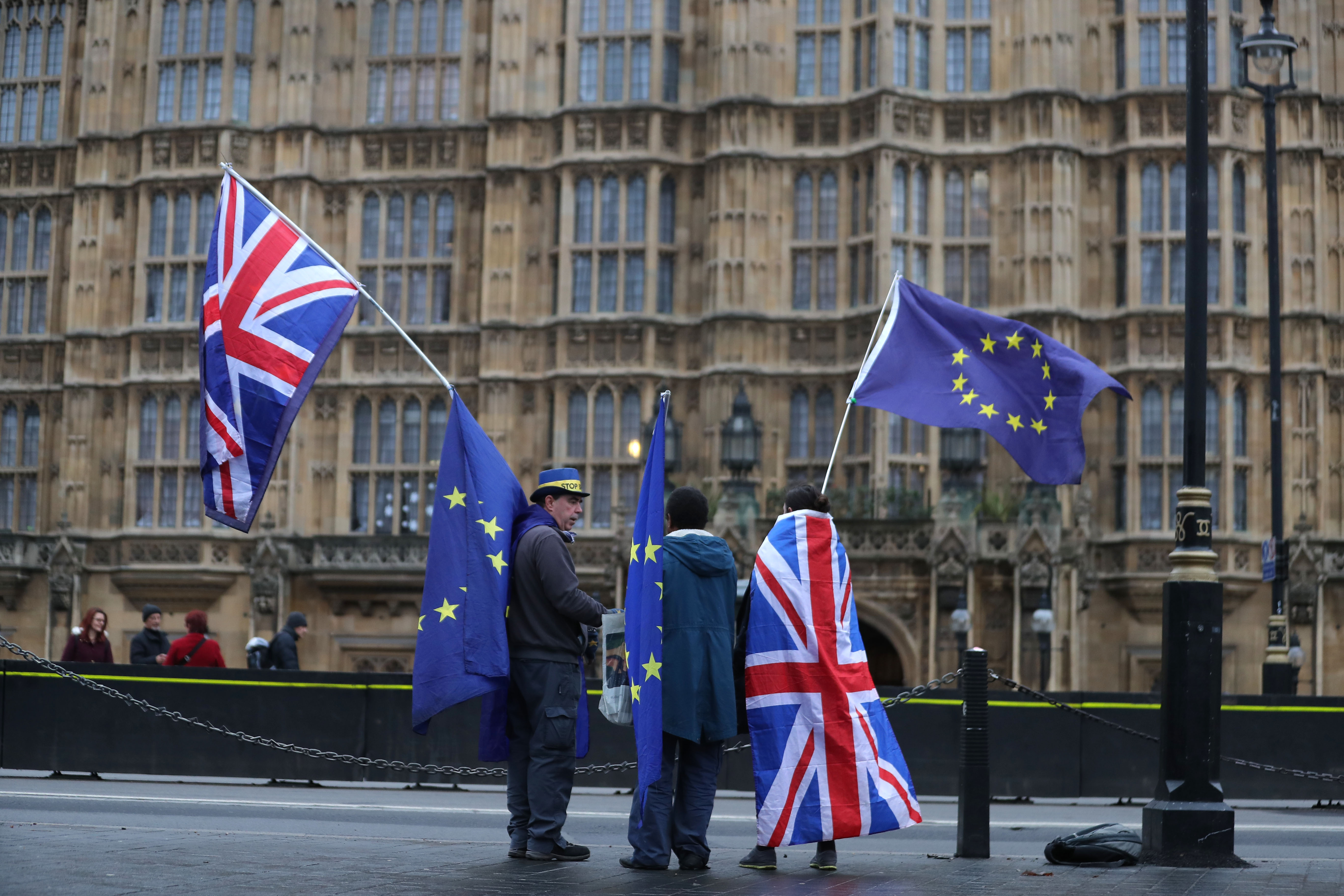 Pro-European Union, anti-Brexit demonstrators hold Union and E.U. flags outside the Houses of Parliament in London on December 21st, 2017.