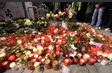 Candles and flowers are displayed outside a grocery store on January 2nd, 2018, where a 15-year-old girl was stabbed to death by her ex-boyfriend in the western German town of Kandel.