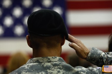 A U.S. Army soldier salutes during the national anthem as soldiers return home from Iraq on August 29th, 2009, in Fort Carson, Colorado.