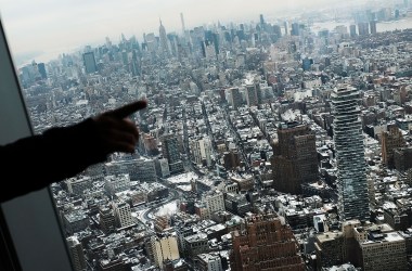 Visitors to the One World Observatory look out at a snow covered Manhattan on January 8th, 2018, in New York City.