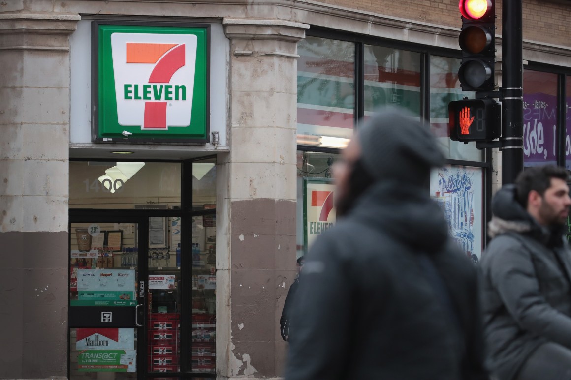 Pedestrians walk past a 7-Eleven store on January 10th, 2018, in Chicago, Illinois.