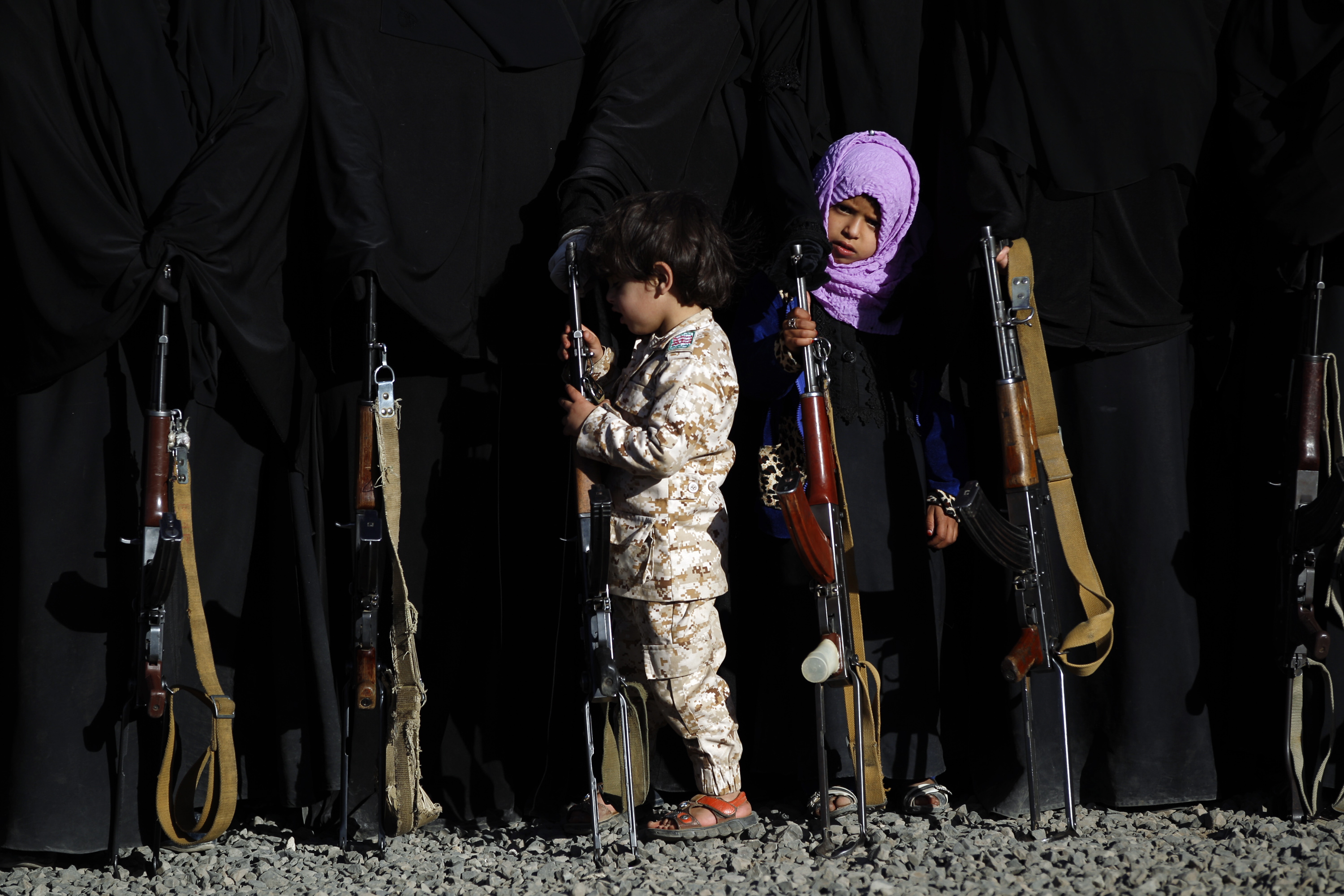 A Yemeni girl holds a rifle as she attends a gathering in Sanaa on January 14th, 2018, in support of the Houthi movement.