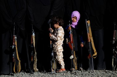 A Yemeni girl holds a rifle as she attends a gathering in Sanaa on January 14th, 2018, in support of the Houthi movement.