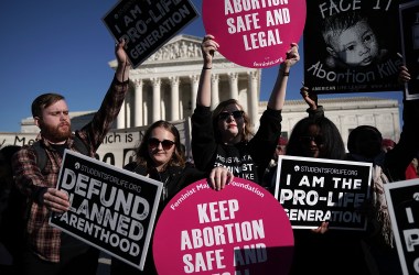 Activists hold signs in front of the the United States Supreme Court during the 2018 March for Life on January 19th, 2018, in Washington, D.C.