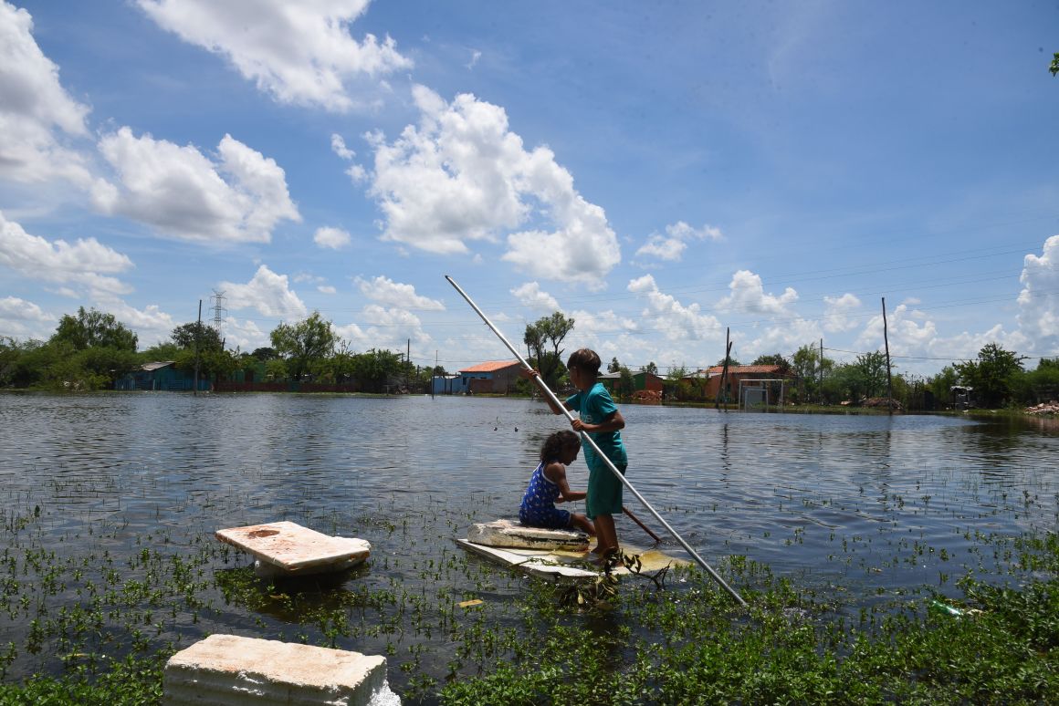 Children play in an Asunción neighborhood on January 22nd, 2018, that was flooded when the Paraguay River overflowed its banks due to heavy rains. The flooding has affected more than 18,000 people in the Paraguayan capital in the past week.