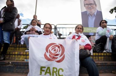 Women hold a banner with the logo of the FARC political party during the launch of the political campaign for president of FARC leader Rodrigo Londono Echeverri, known as "Timochenko."