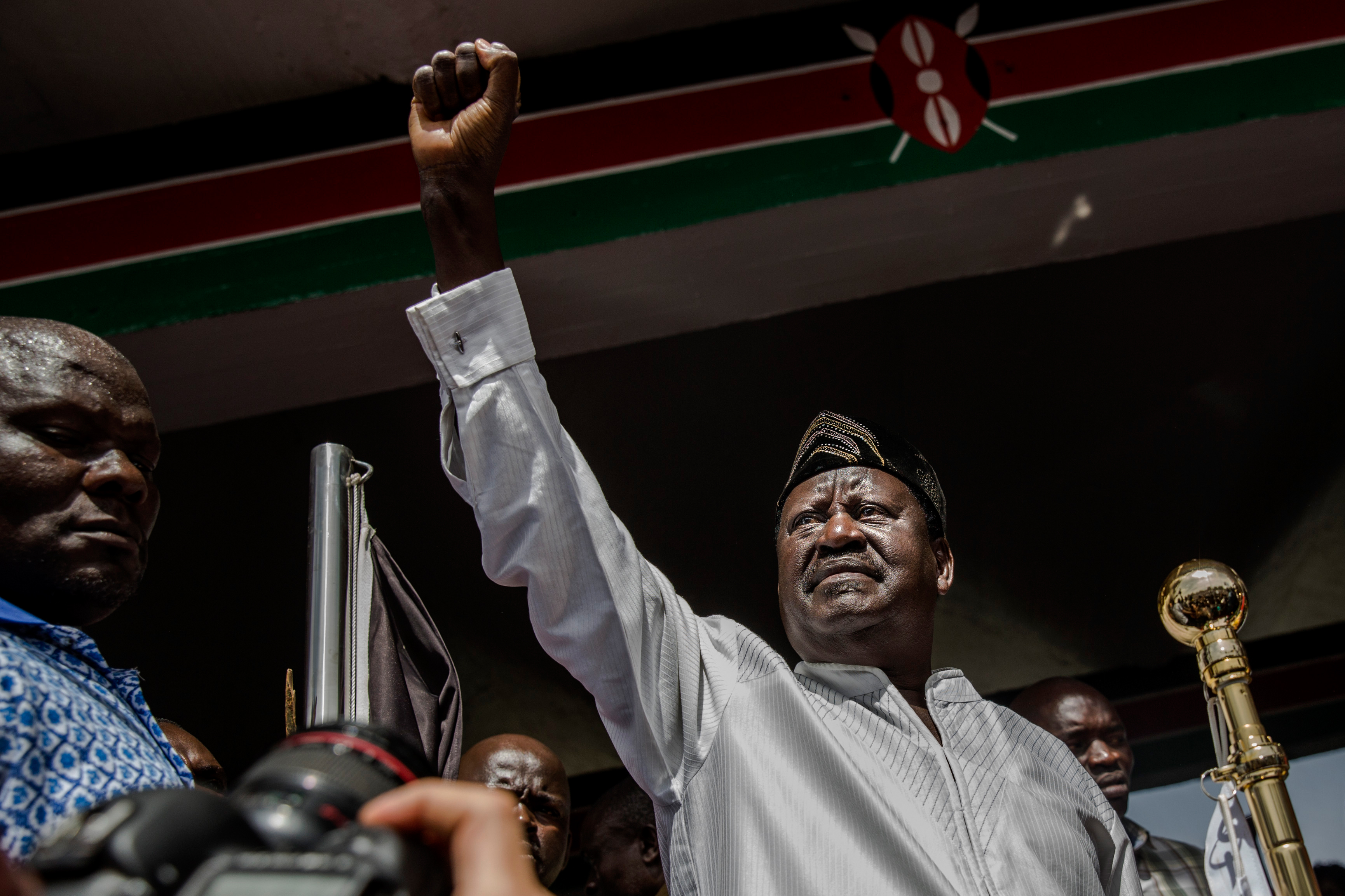 Kenyan opposition National Super Alliance coalition leader Raila Odinga gestures before swearing himself in as the 